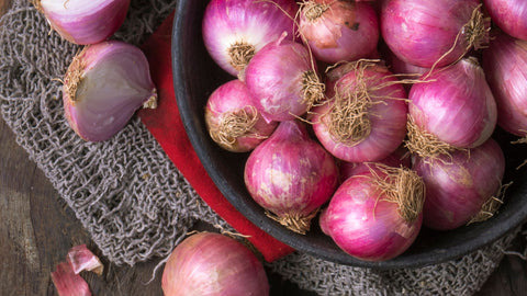 A bowl of organic red onions.