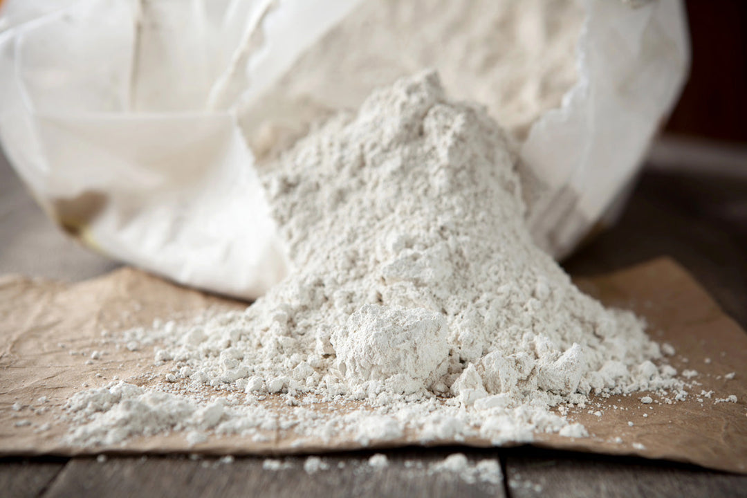 Diatomaceous earth pouring out of a bag.