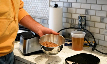 A man demonstrating how to make bone meal. 