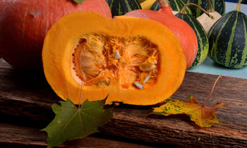 A pumpkin cut open to reveal the seeds.