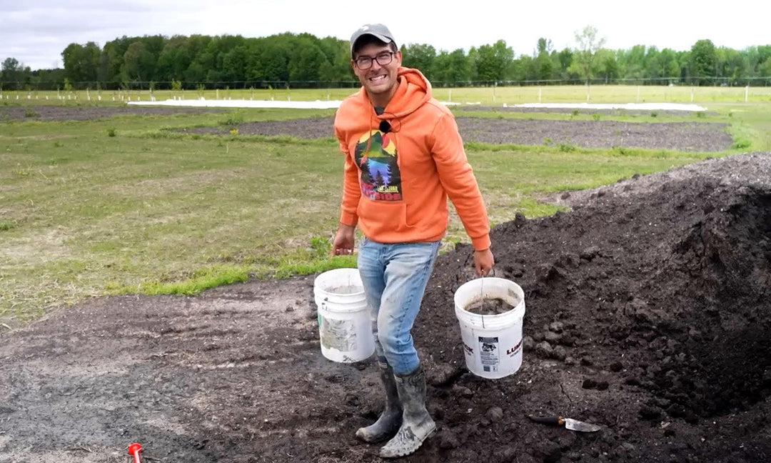 A man demonstrating how to make compost tea.