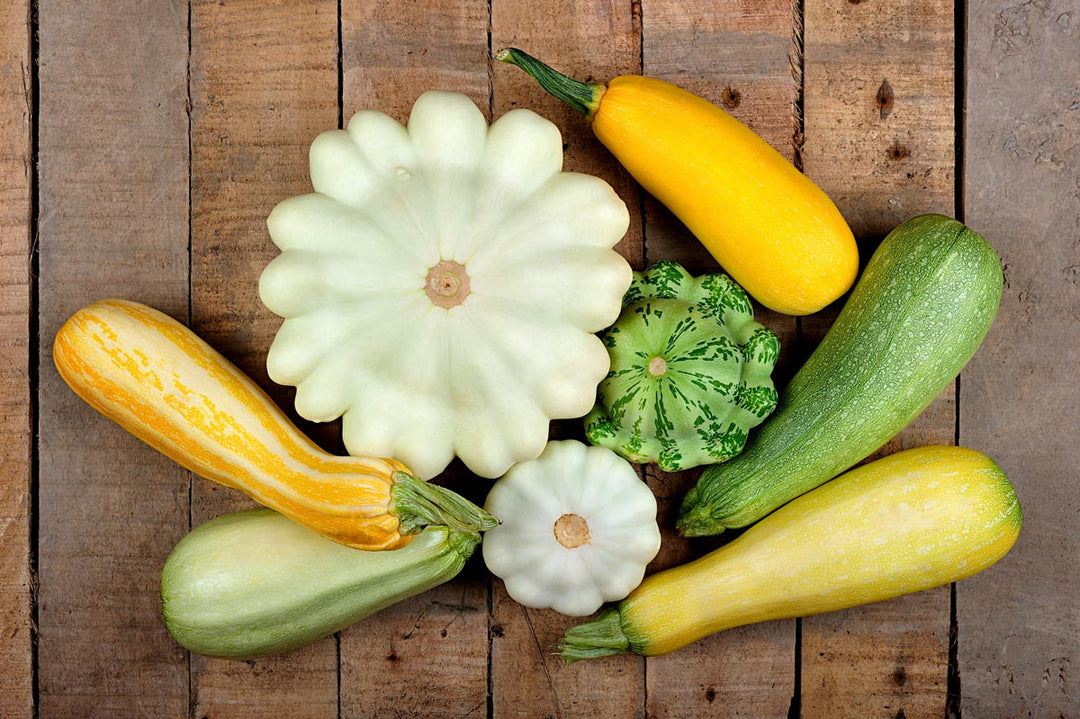 Various summer squash on a table.