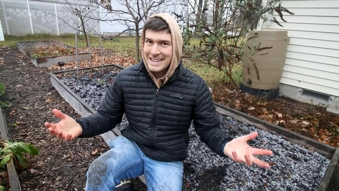 A man sitting in a frosty garden in March.