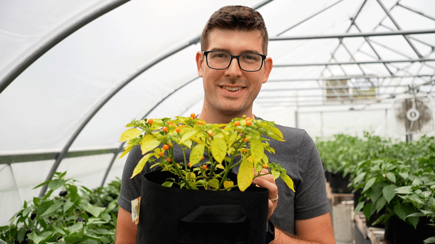 A man holding a potted plant.